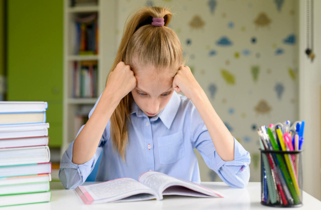 a young girl struggles with her homework due to a visual problem