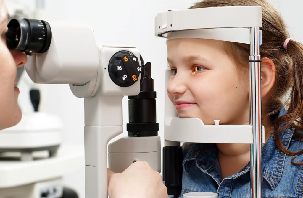 A young girl undergoing an eye examination with advanced equipment to assess progressive myopia.